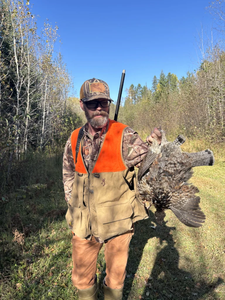 Grouse Hunter with Harvest in the Field in Northern Minnesota on a Public ATV Trail